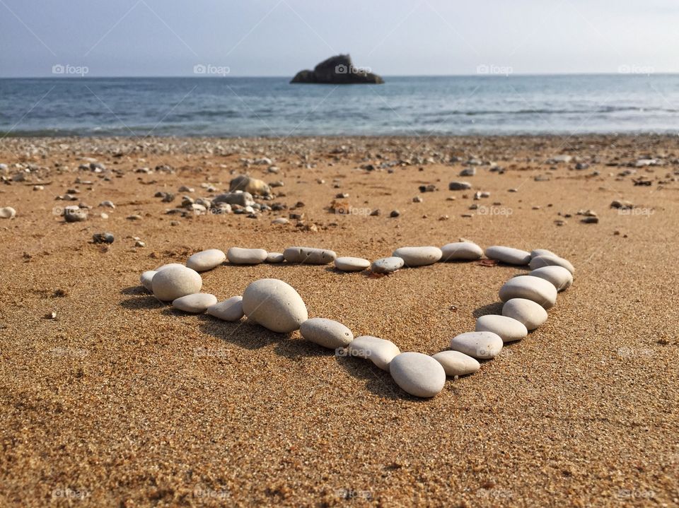 Heartshape on beach with pebbles