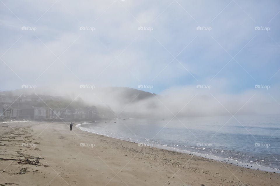 Taking a walk on the beach in the fog
