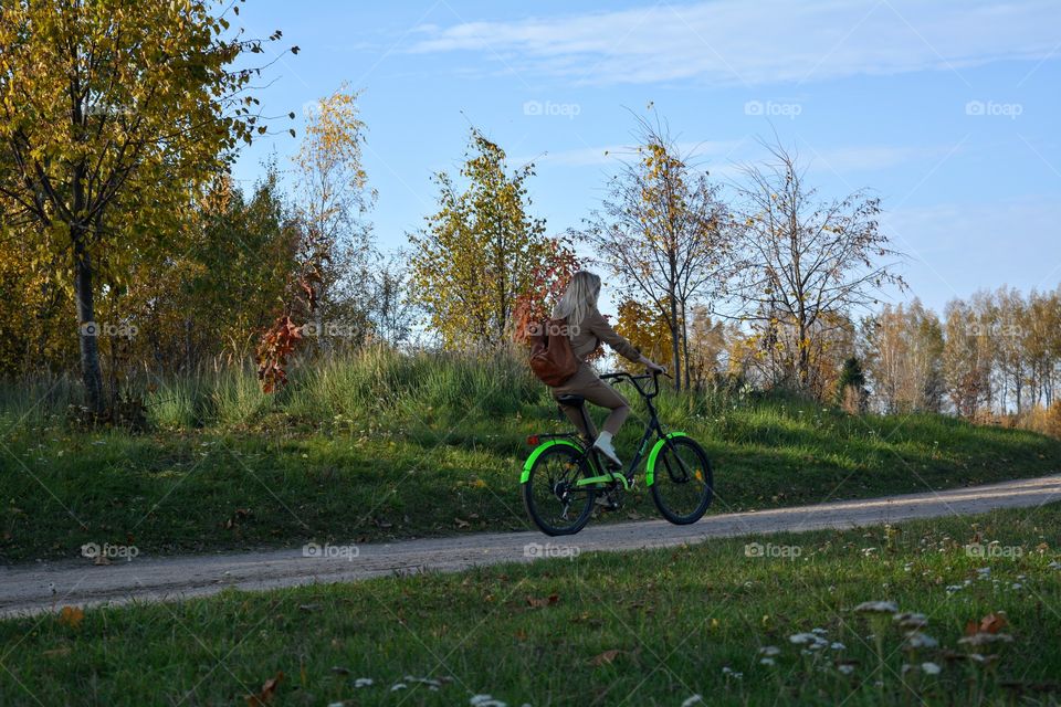 person riding on a bike autumn landscape, social distance