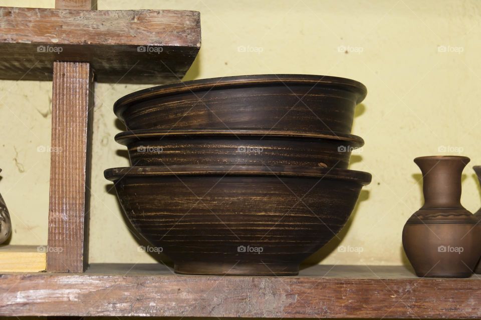 Clay pots in a potter's workshop.  Preservation of the culture and traditions of pottery.