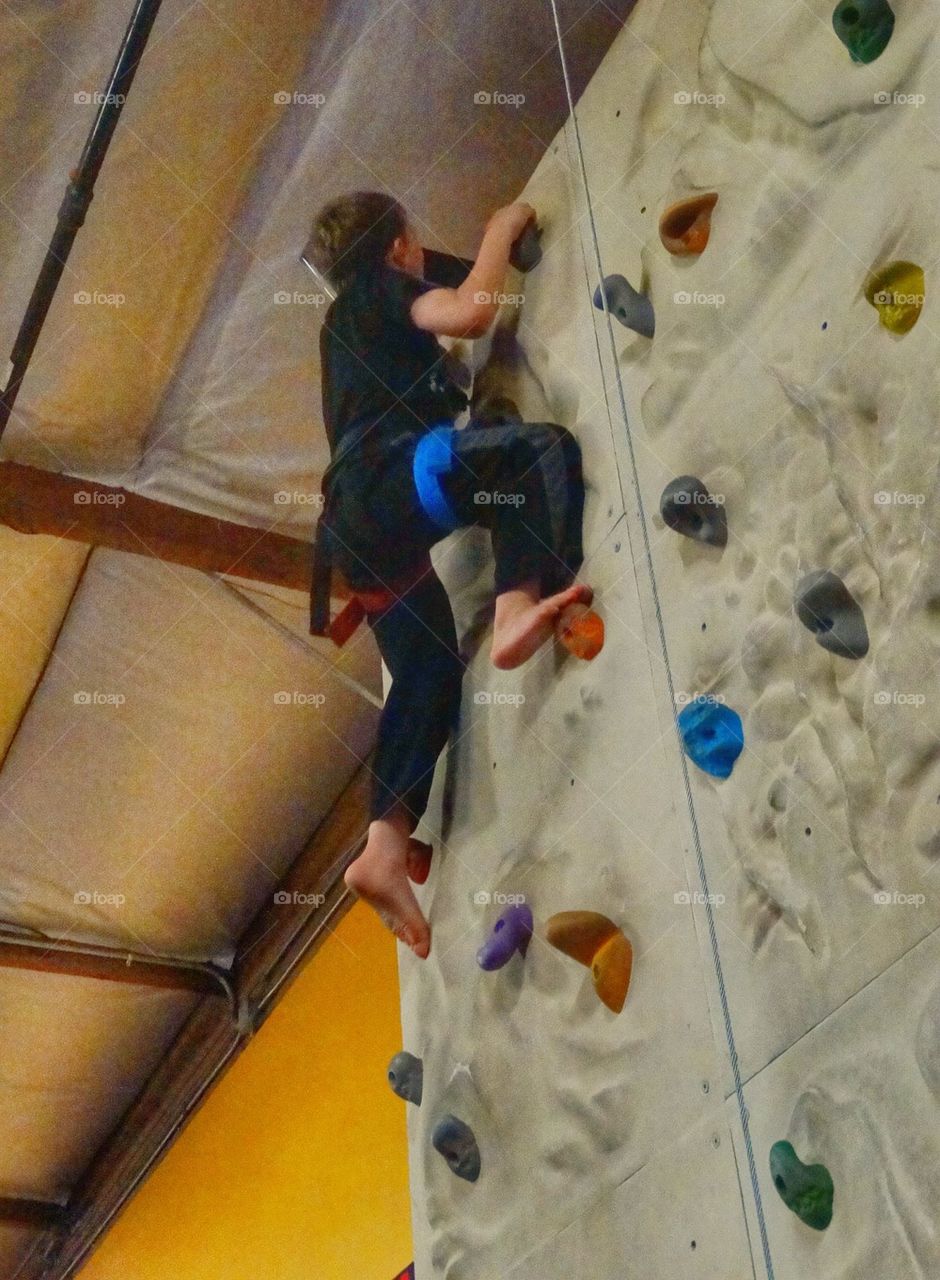 Child Climbing Rock Wall