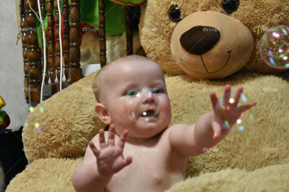 Baby catching bubbles