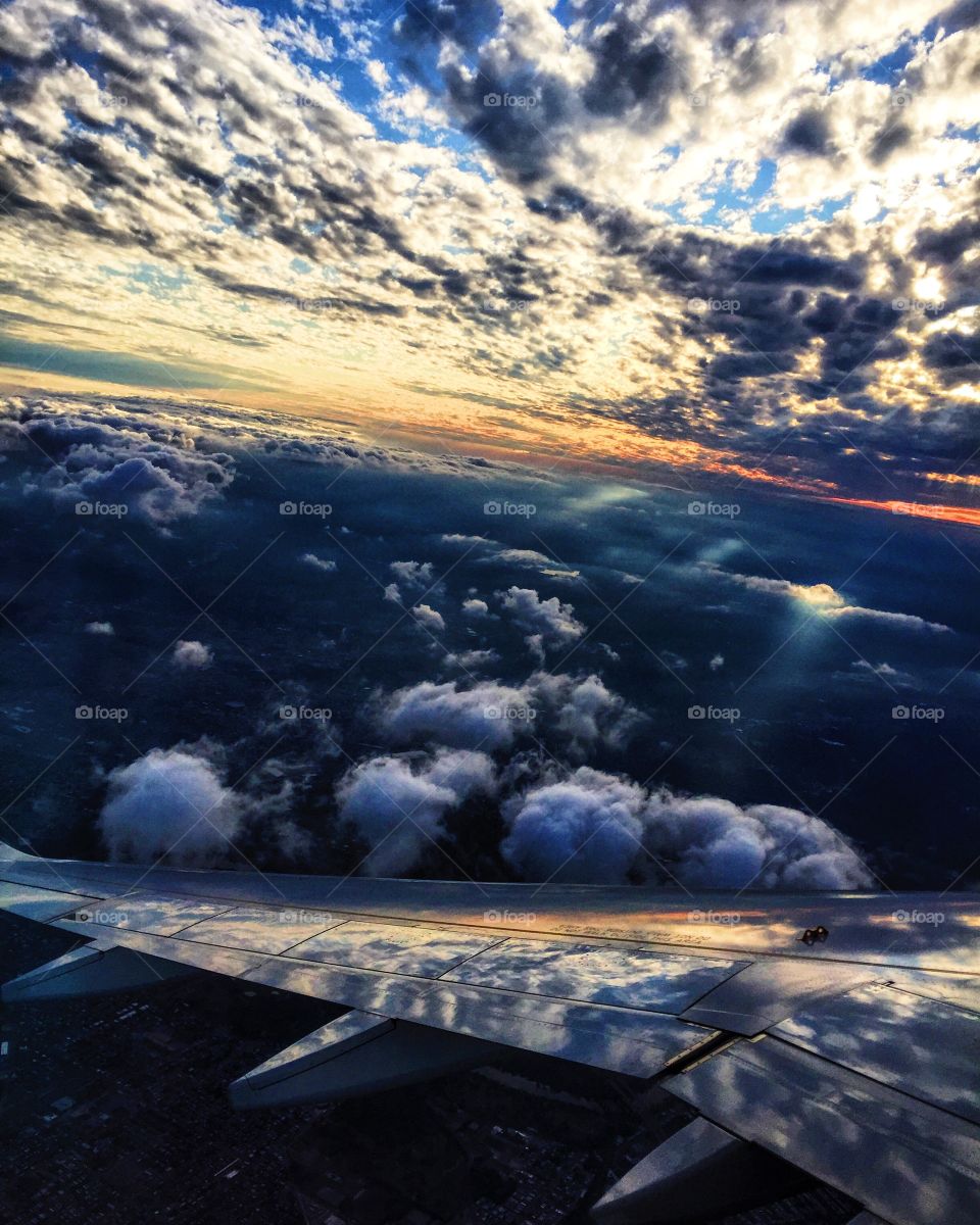 Cropped image of airplane flying over cloudy sky