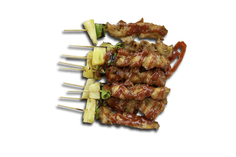 Isolated BBQ grilled Chicken with vegetables and tomato sauces on a white background with clipping path.