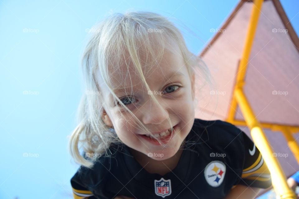 Girl smiling in football jersey 