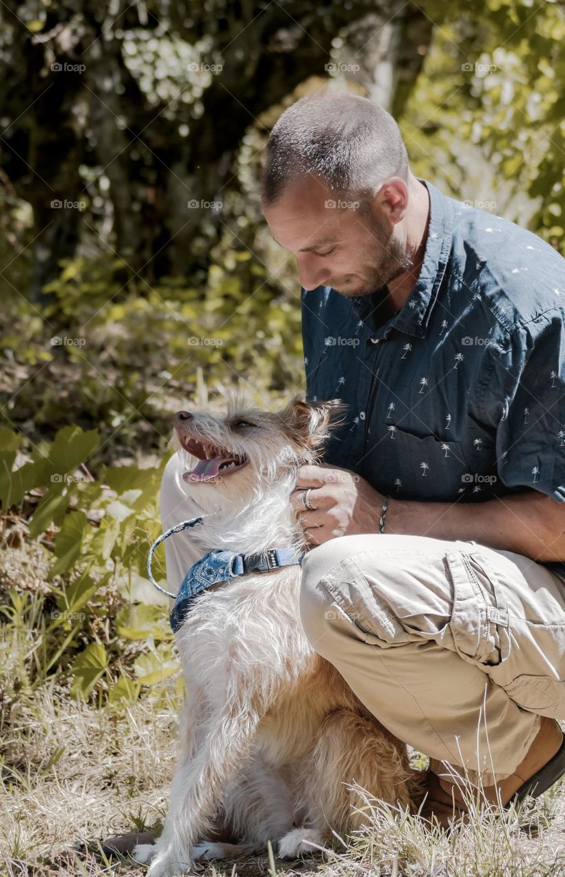 A happy dog enjoys a fuss from her owner