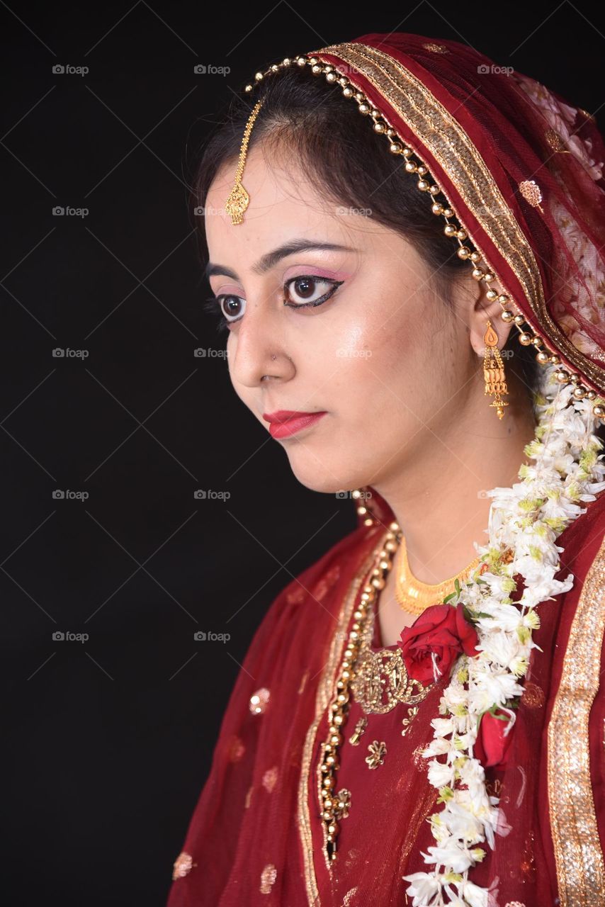 Portrait of a lady wearing heavy gold jewellery