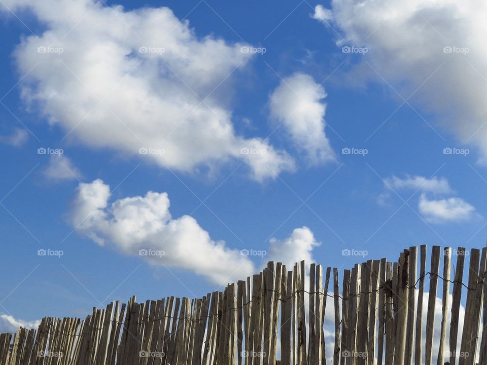 Blue sky behind the fence