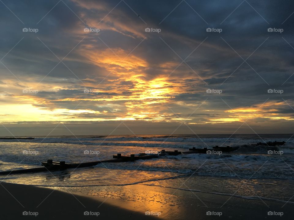 Ocean sunrise with beautiful clouds in the sky