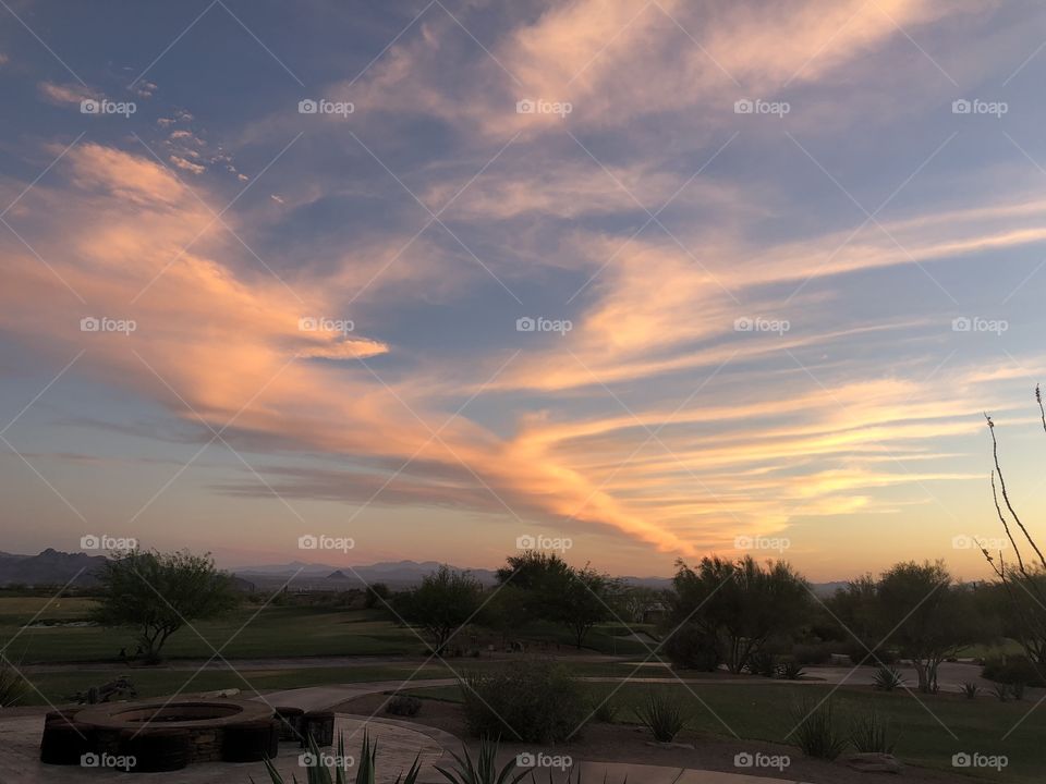 A stunning desert sunset in Tucson, Arizona featuring a stunning cloud array. 