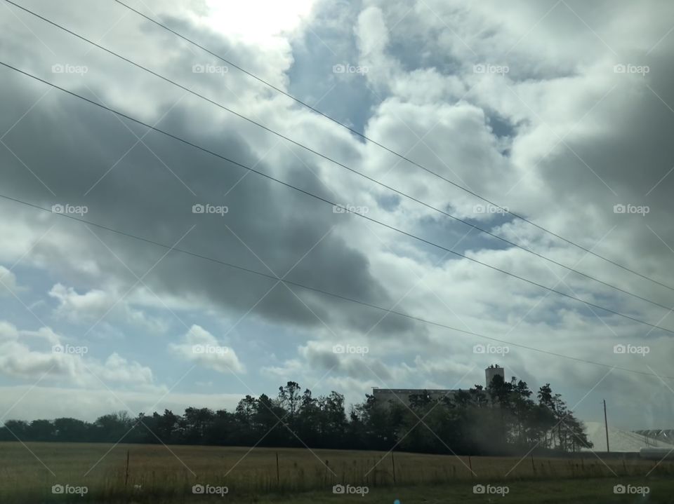 Dark creepy clouds cluster above a grain elevator