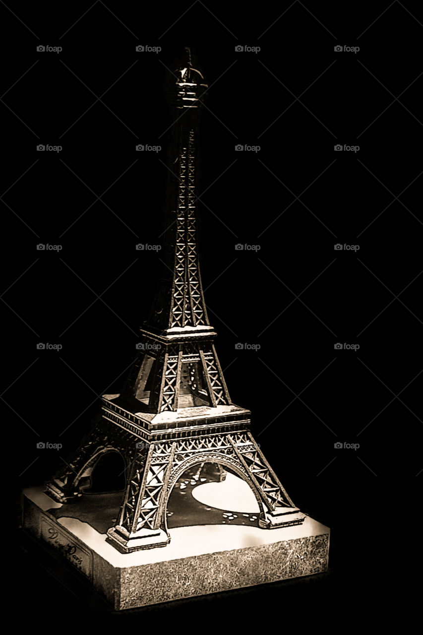 Eiffel Tower souvenir.  Image with focus on base and shadows.