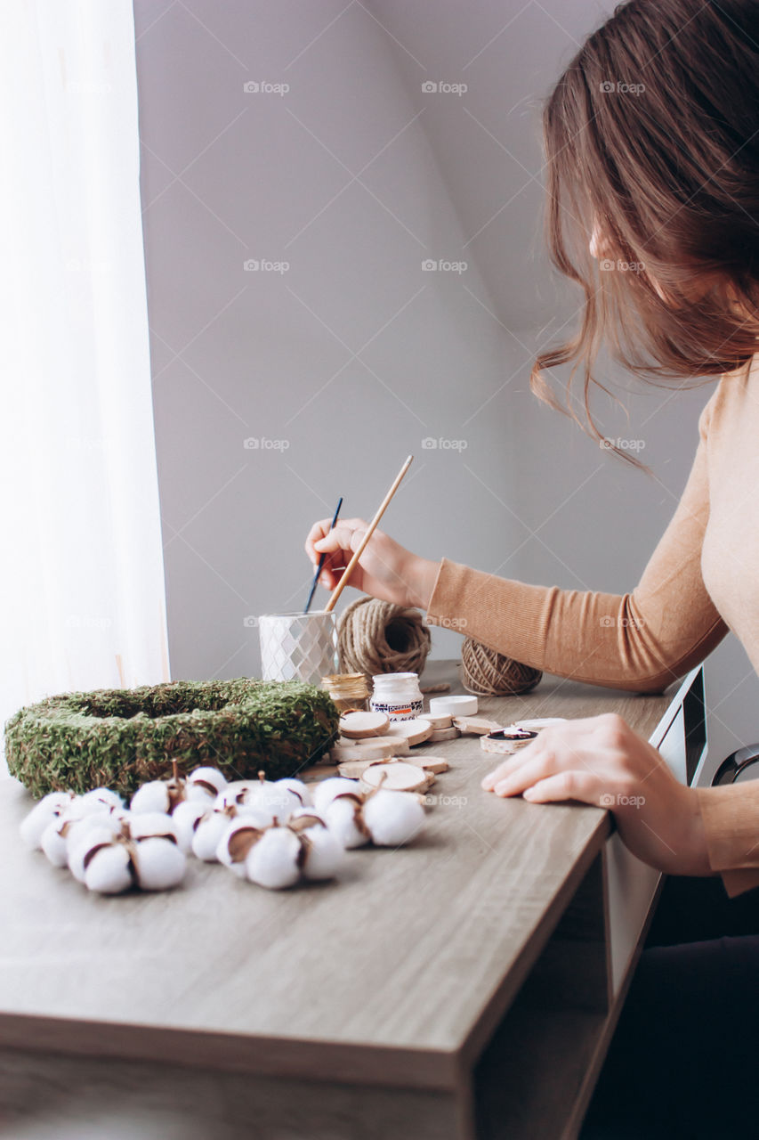 photo of a woman crafting an Easter wreath made only from eco friendly materials