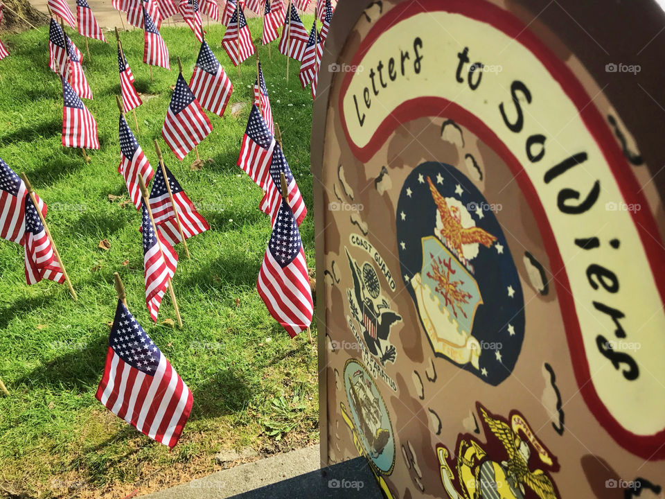 American flags with a mail box for letters to soldiers