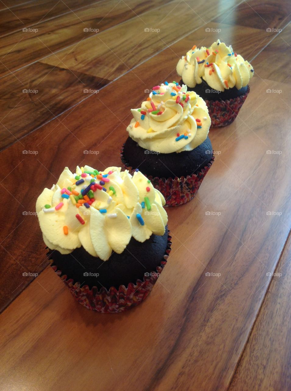 Chocolate cupcakes with rainbow sprinkles.