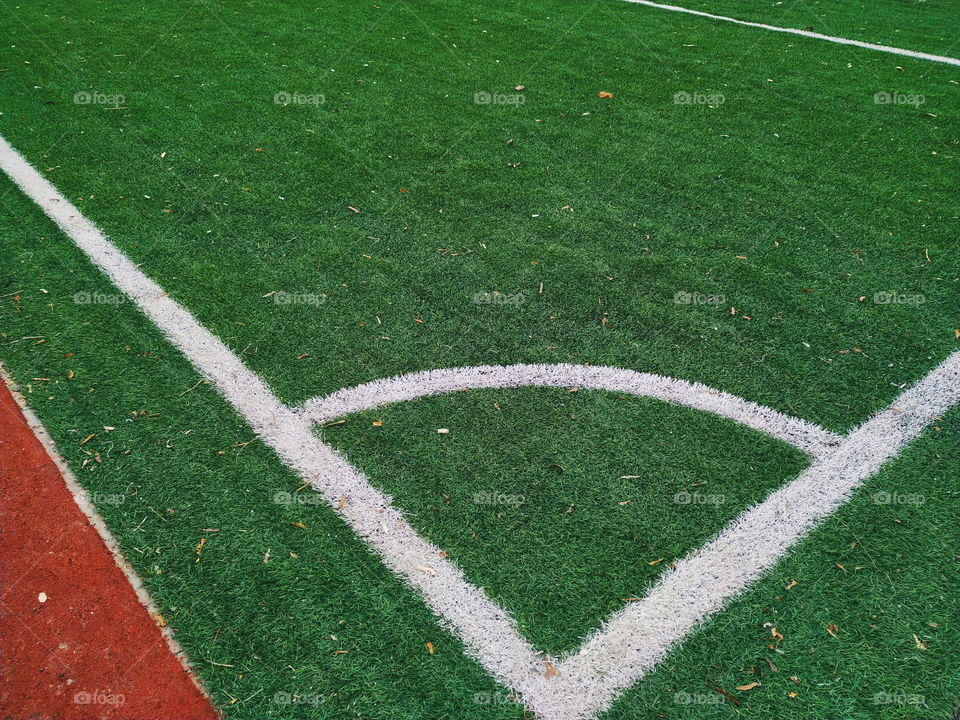 white markings on the green grass of a football field
