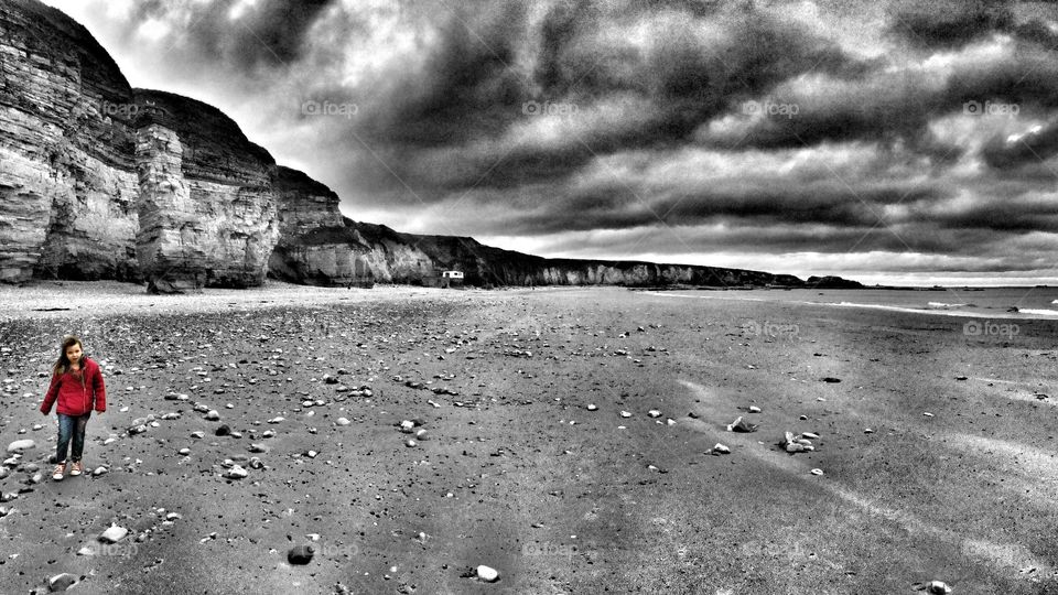 Young girl walking at an empty beach