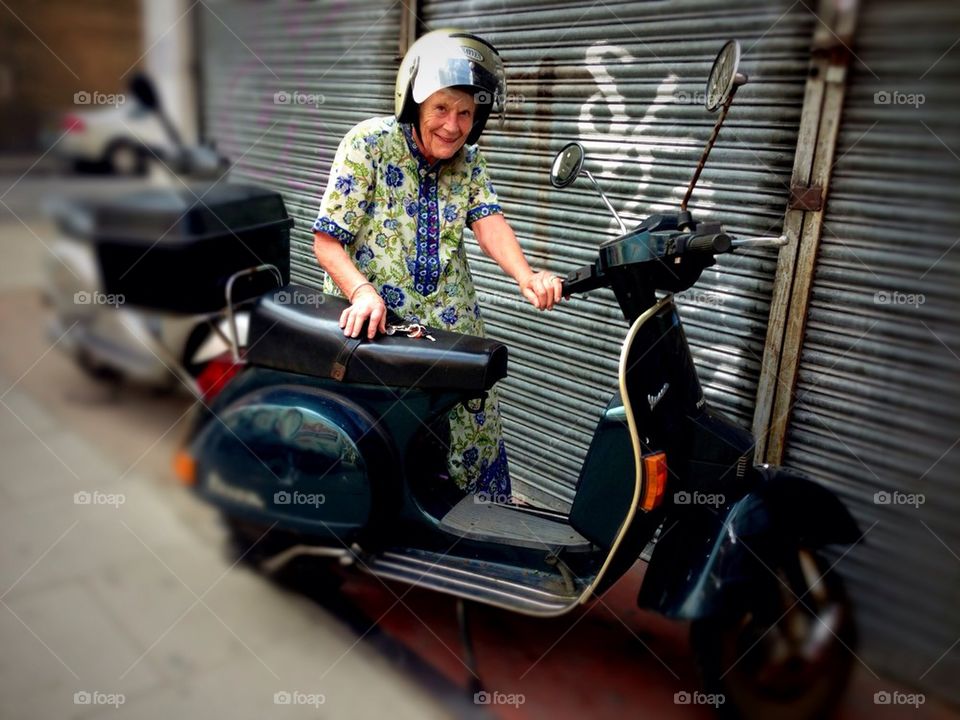 Vintage blue vespa  scooter lovely elderly lady rider