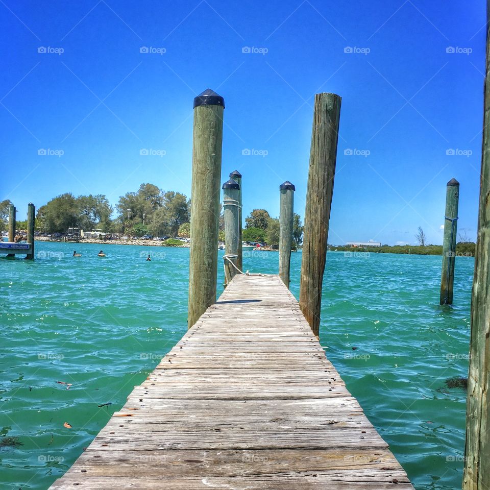 Wooden pier against clear sky