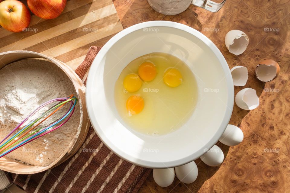 Making homemade puffed apple pie with eggs, sugar and flour.