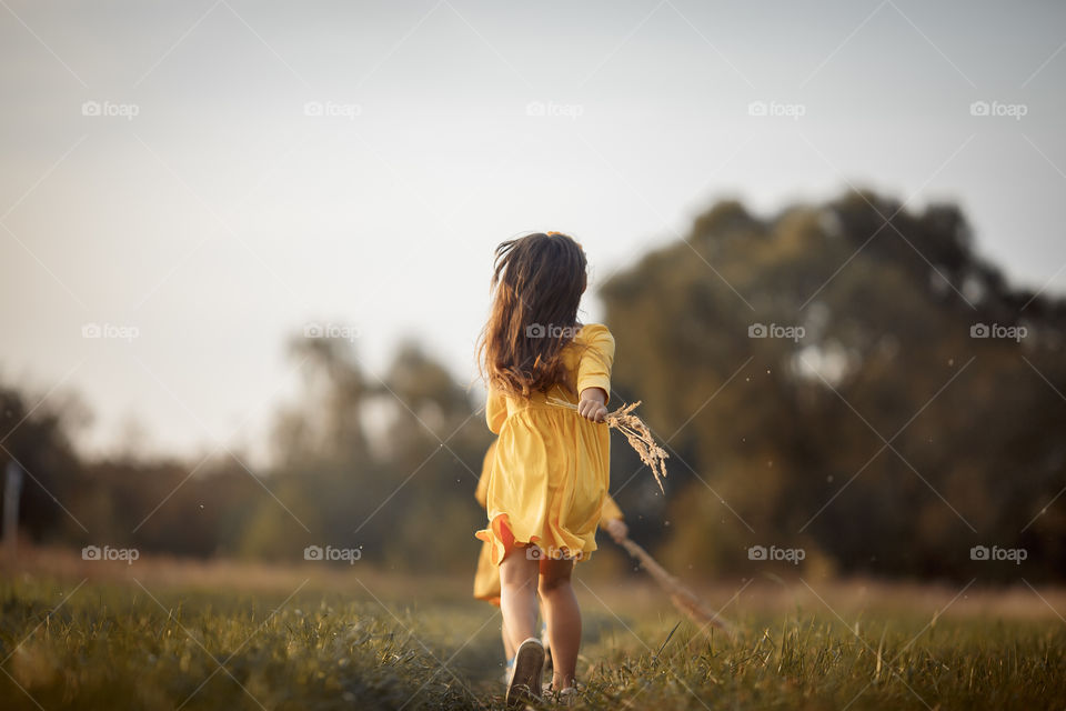 Little girl in yellow dress outdoor portrait 