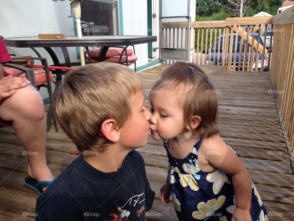 Little girl kissing a boy