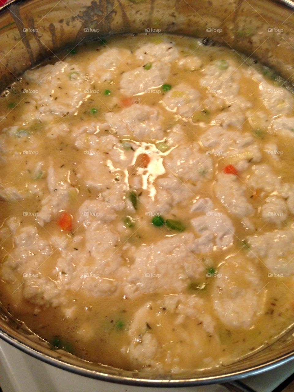 Vegan Chicken and Dumplings, made with vegetable stock, peas, carrots, homemade dumplings with flour, soy and several seasonings. 