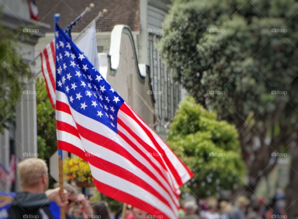 Waving The American Flag. Fourth Of July Mainstreet Parade
