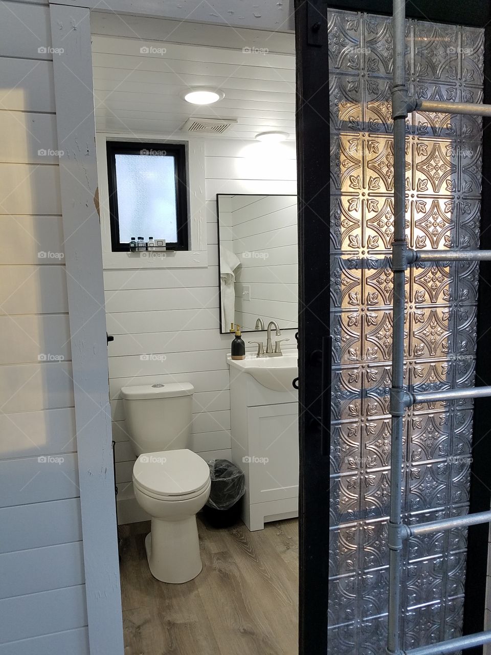 Metal sliding door on tiny house bathroom