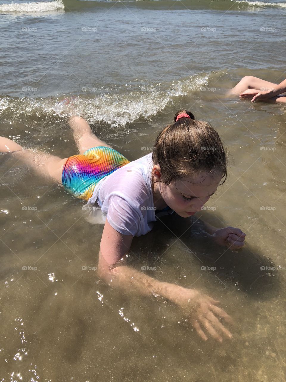 Girl at Galveston Beach plays in water