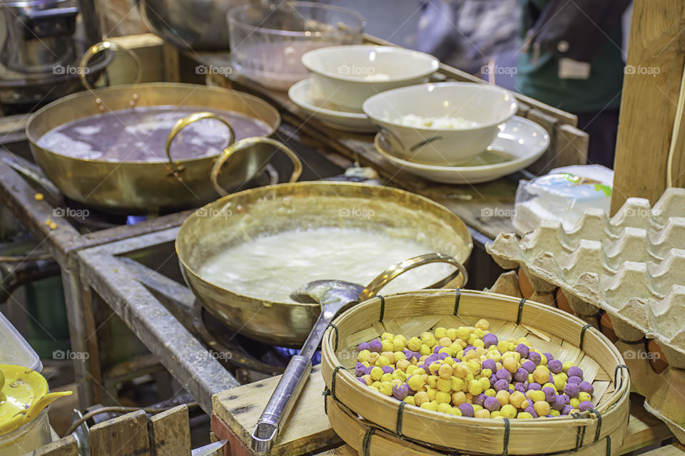 Thai dessert or Bua loi , Dumplings rice ball on bamboo tray and coconut milk.