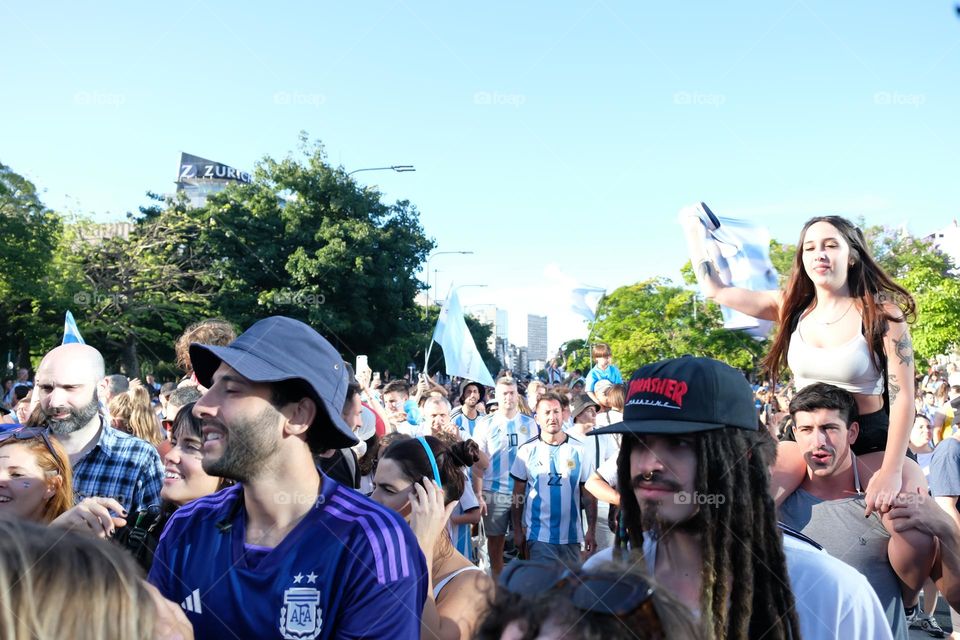 Buenos Aires - 18.12.2022: Football fans in t-shirts of the national team of Argentina celebrating victory on the street