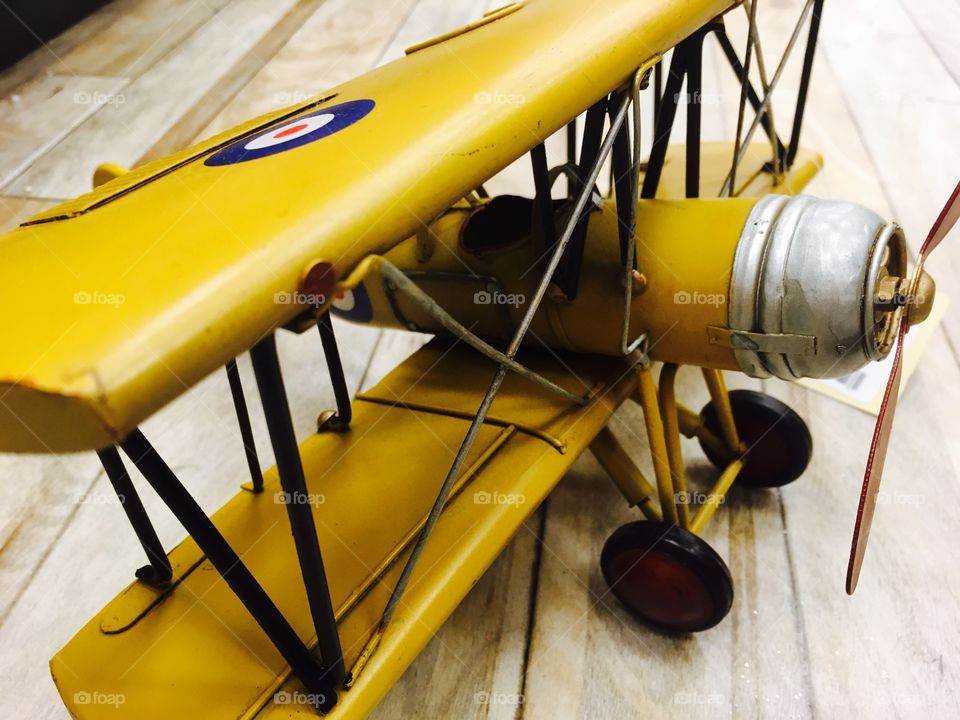 This is a very close capture of small yellow vintage plane. 