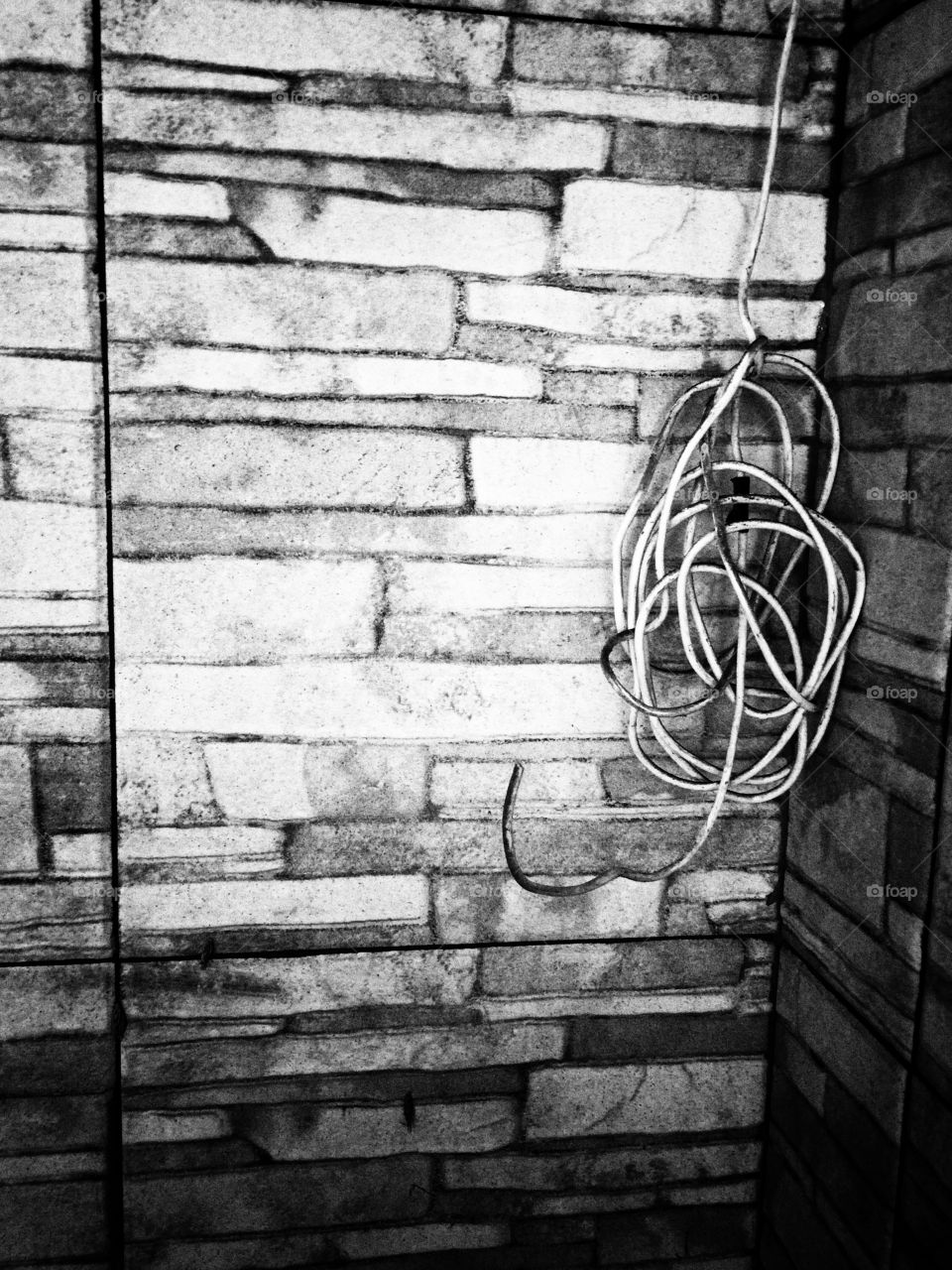 Old wire with stone wall background 