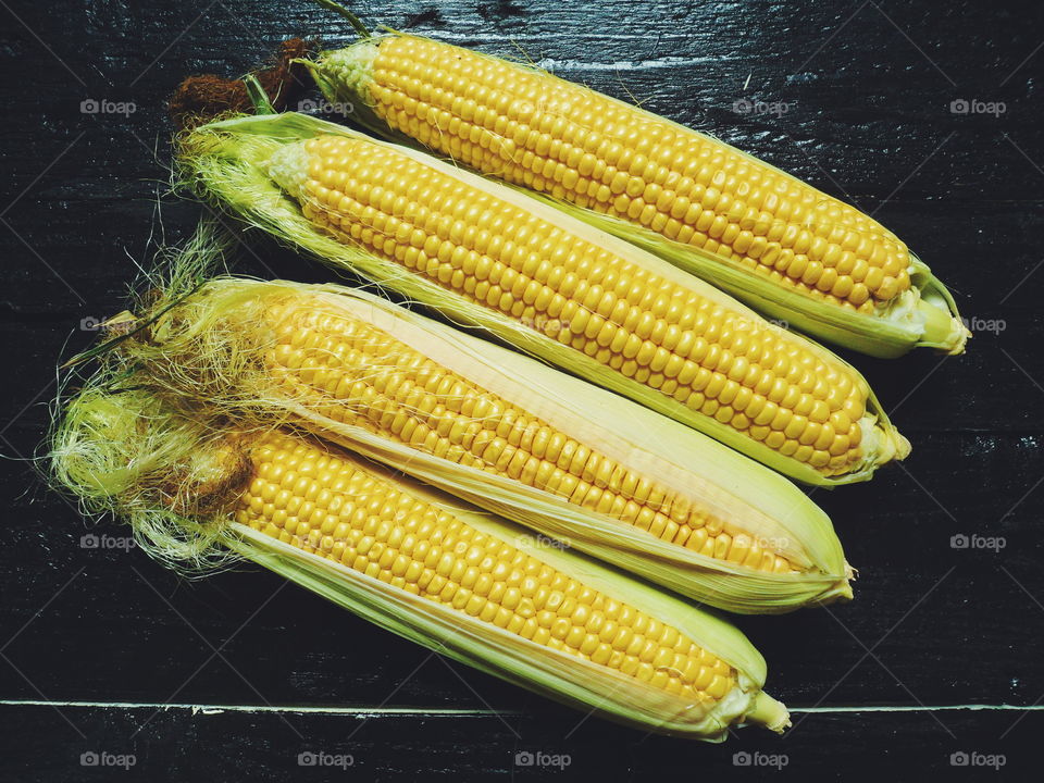 yellow corn on black, vegetables