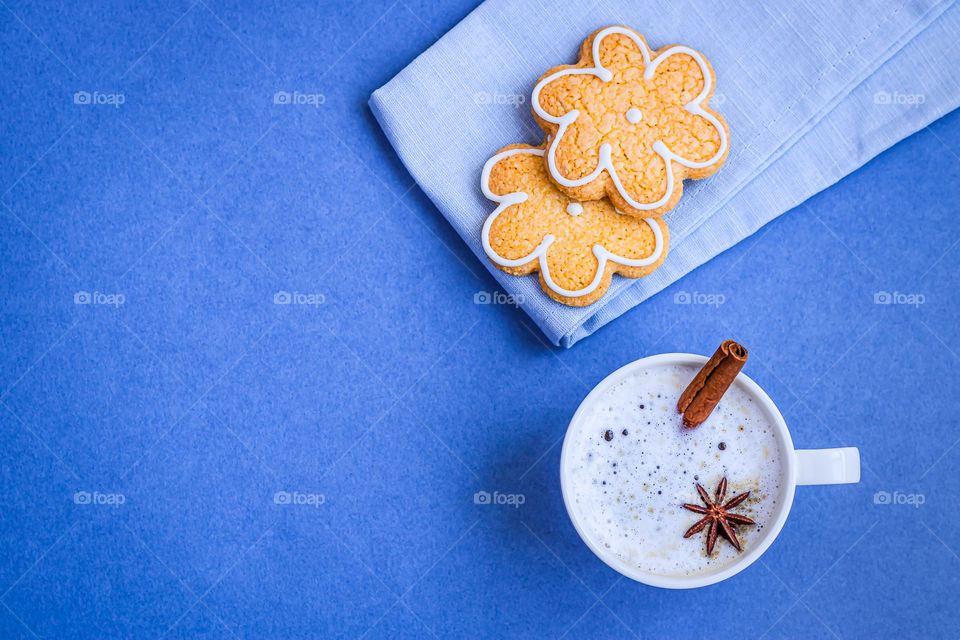 Top view to cup with cappuccino and some cookies.