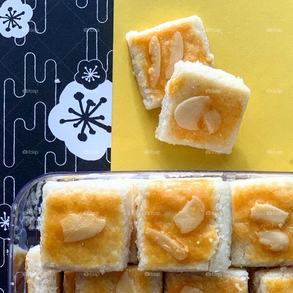 Almond cookie in pretty festive yellow background setting for celebrations 