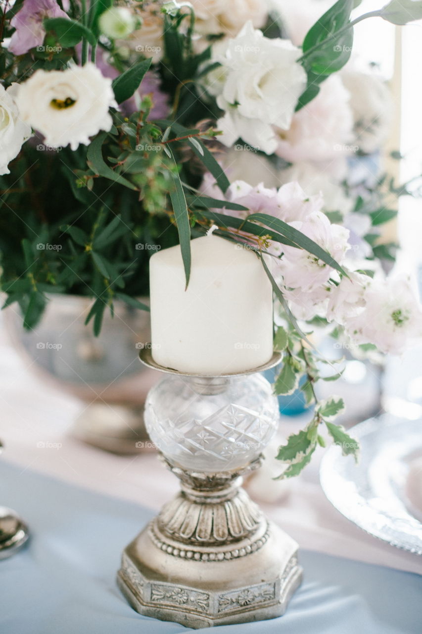 Silver candlestick as element of festive table wedding centerpieces decorations.