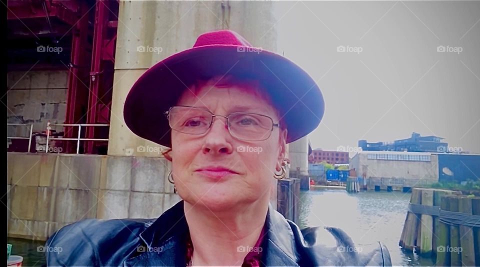 This is me, „Petra Schiller“ a.k.a. „Maxine Firefox“ standing in the parking lot underneath the „Pulaski Bridge“ at „Newtown Creek“ in LIC, Queens on a Fall day in 2022. Hypnotic Productions