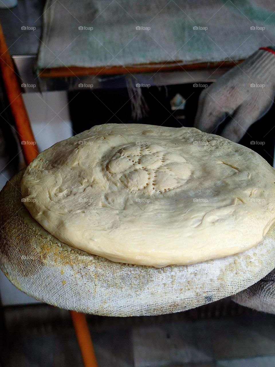 Baking bread pita bread.  On a special platform lies a ready-made lavash dough