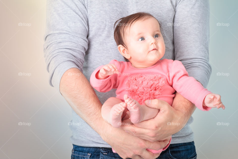 Father carrying cute daughter