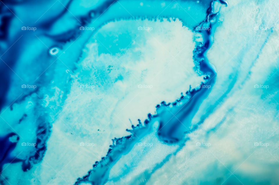 The ink to refill the printer cartridge was spilled onto the white washbasin and the paints blended into abstract drips and patterns.