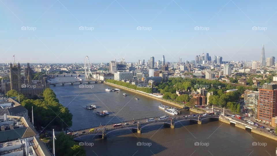 View over central London on a sunny day, including the River Thames, Houses of Parliament, the City and the Shard