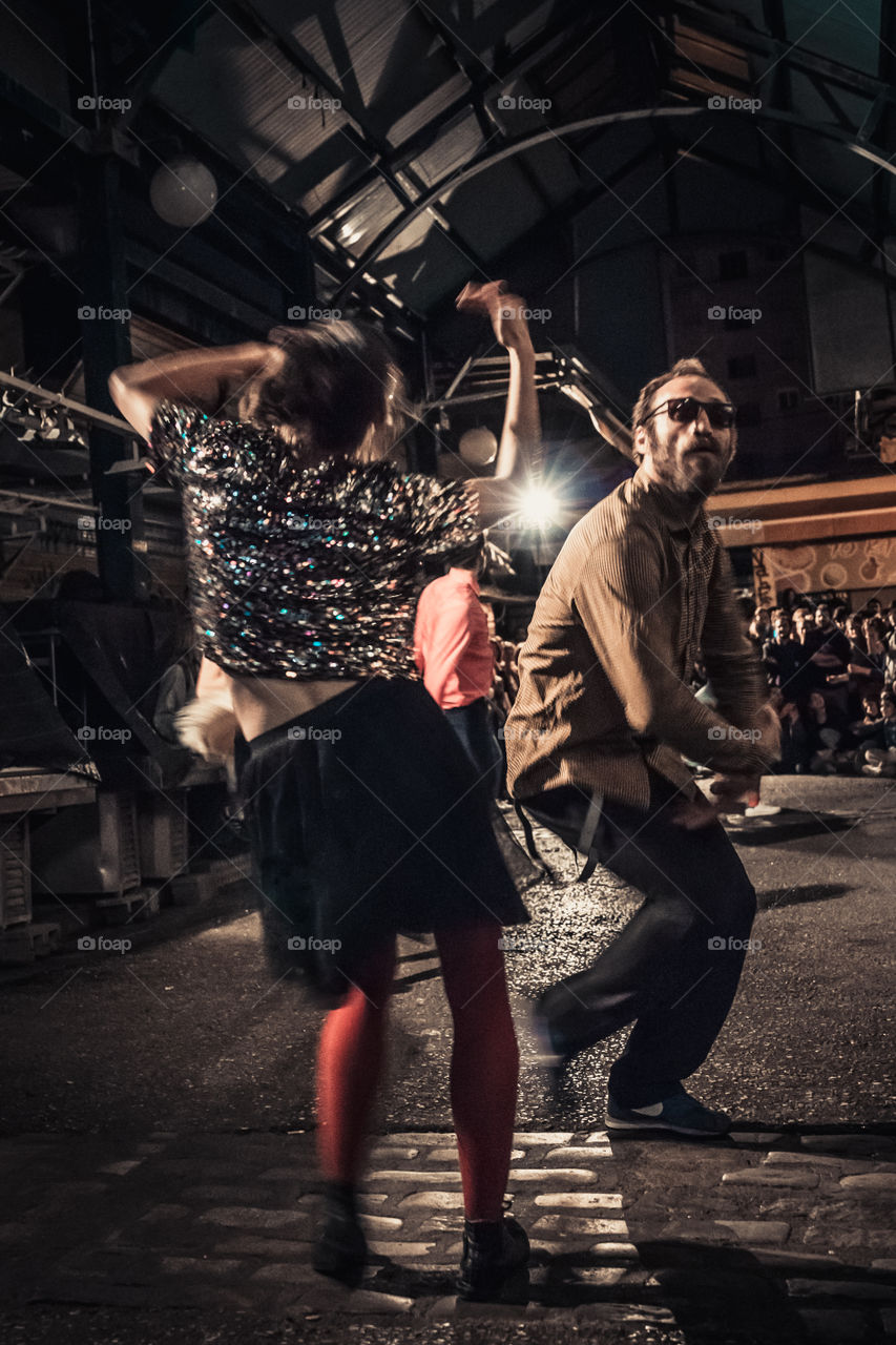 Street Dancing In The Night With Crowd Of People Watching
