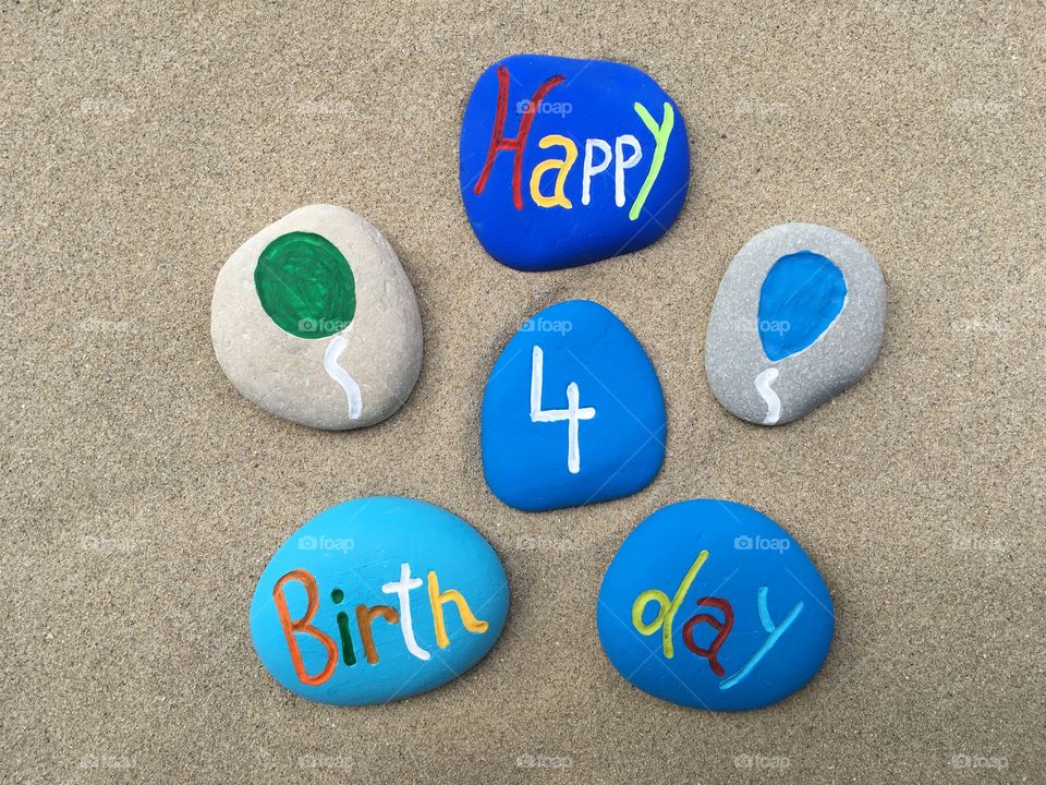 Happy 4 Birthday on colored stones