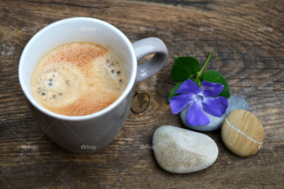 cup of coffee on a wooden background with zen cairn stones