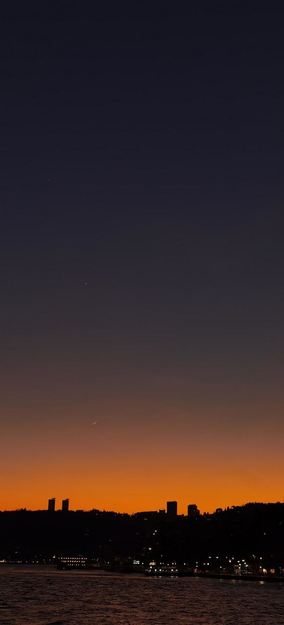 Sunset in Istanbul with crescent moon and shining stars in the sky