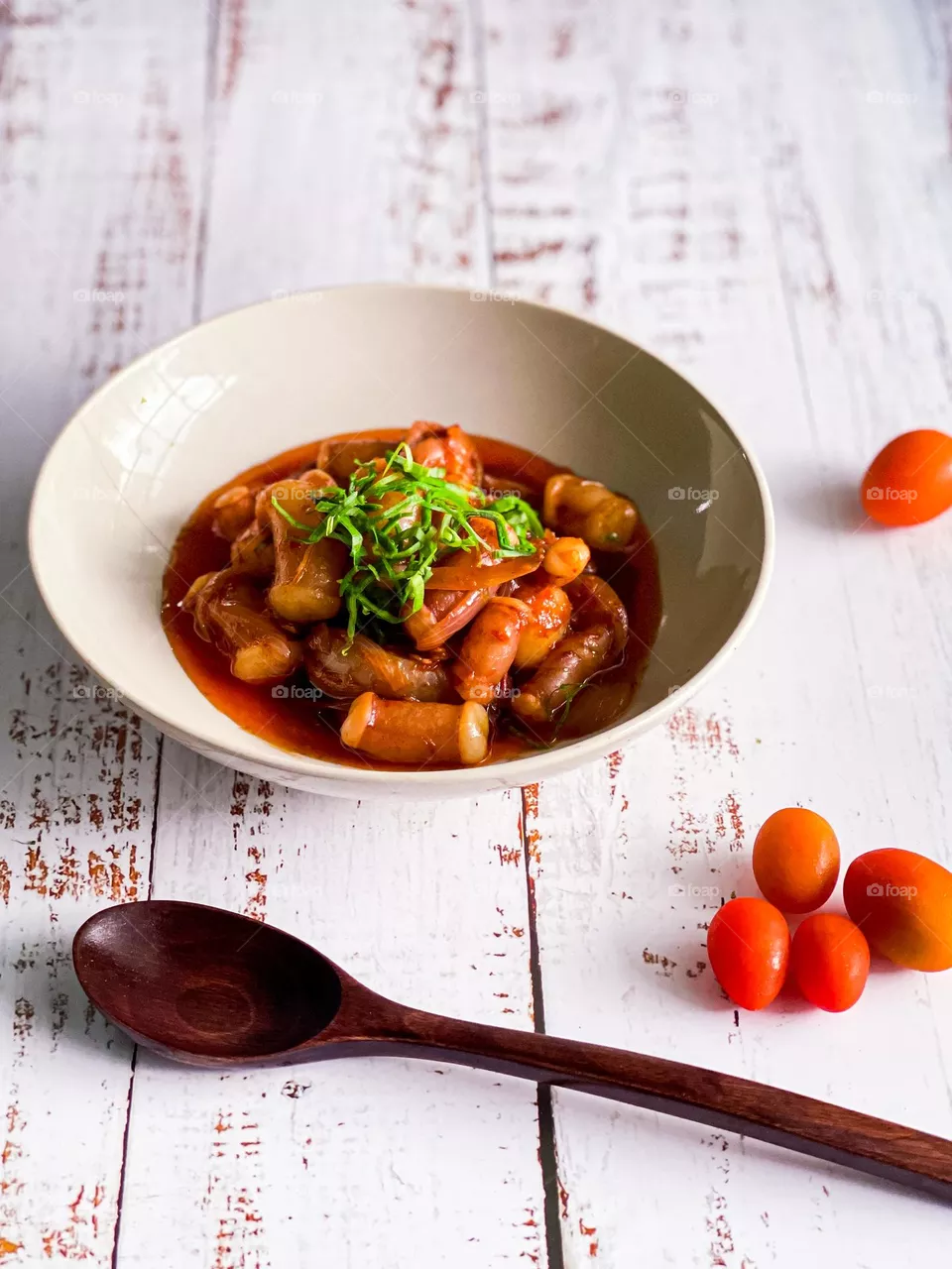 Spicy seafood dish on a white wooden table. Close up view