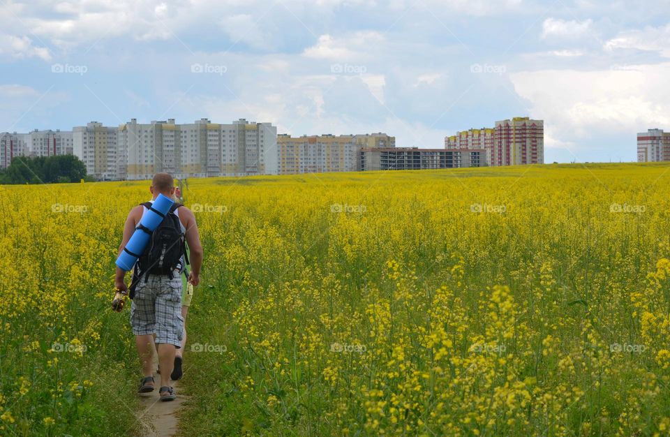 summer time city and field and people walking