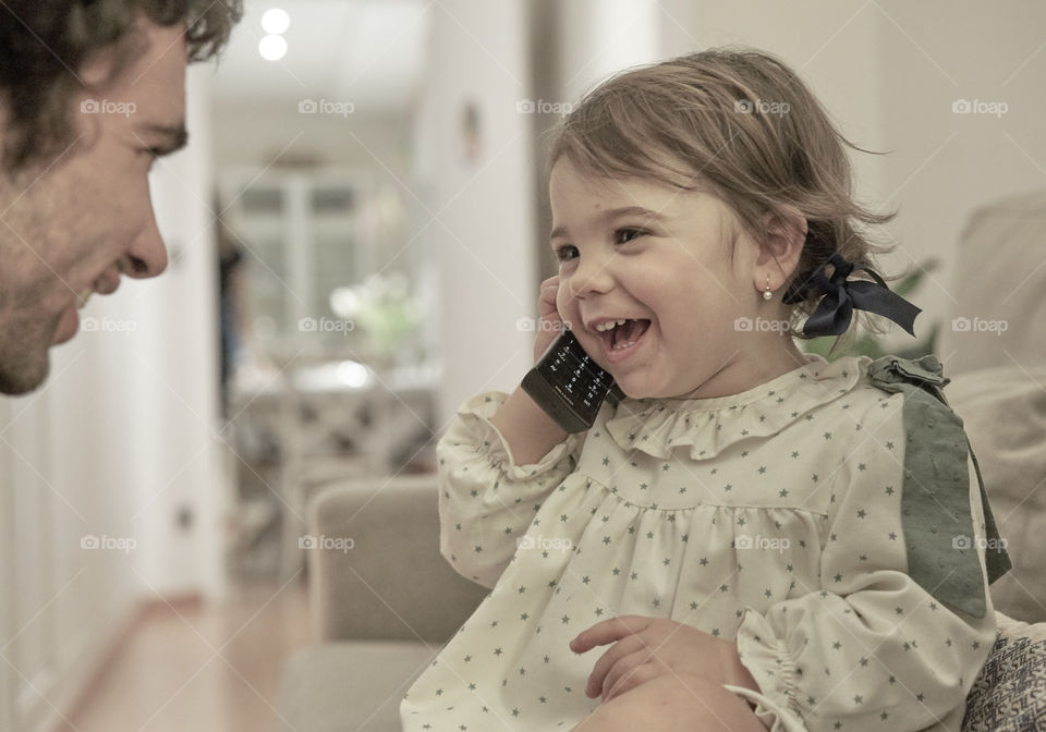 Indoor portrait of toddler with a telephone